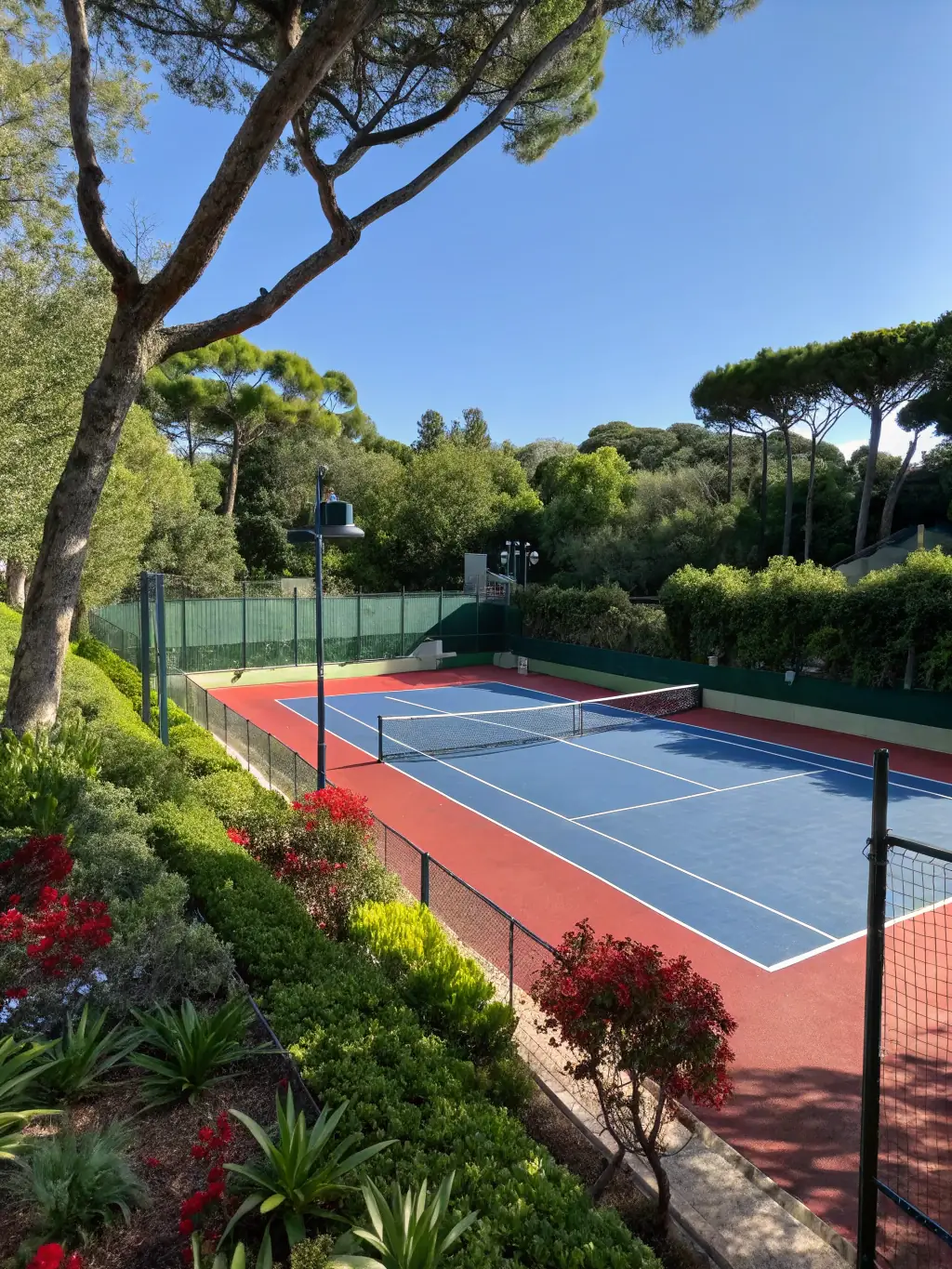 A well-maintained clay tennis court at TENNIS CLUB DE NERONDES OUROUER, showcasing the fresh lines and surrounding greenery, emphasizing the quality of the playing surface.